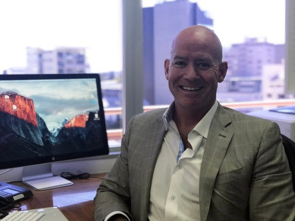 Dr Cutbush back in his office after visiting surgeons overseas
